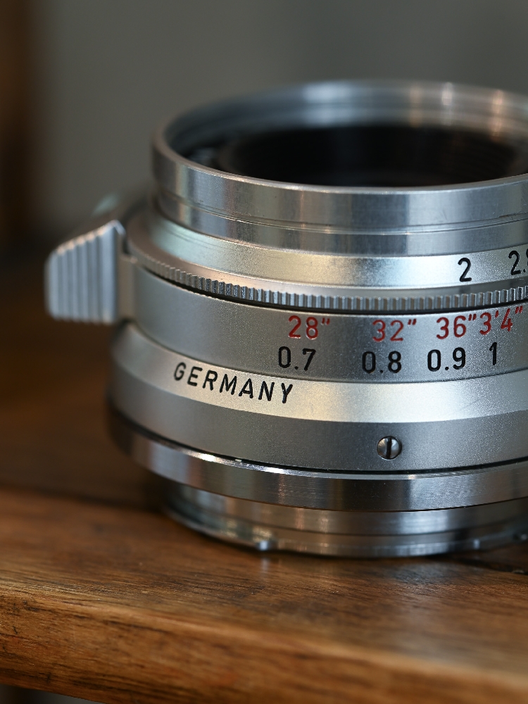 Close-up of a Leica Summicron 35mm 8-element barrel showing the GERMANY engraving, red feet scale and focusing tab