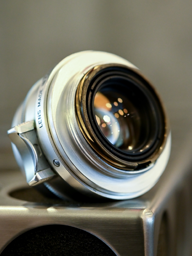Front element and coating of a Leica Summicron 35mm f/2 8-element lens, showing the brass retaining ring