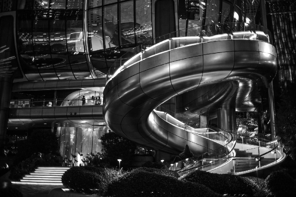 Black and white night photograph of a spiral staircase in Hong Kong shot with a Leica Summicron 35mm f/2 8-element lens