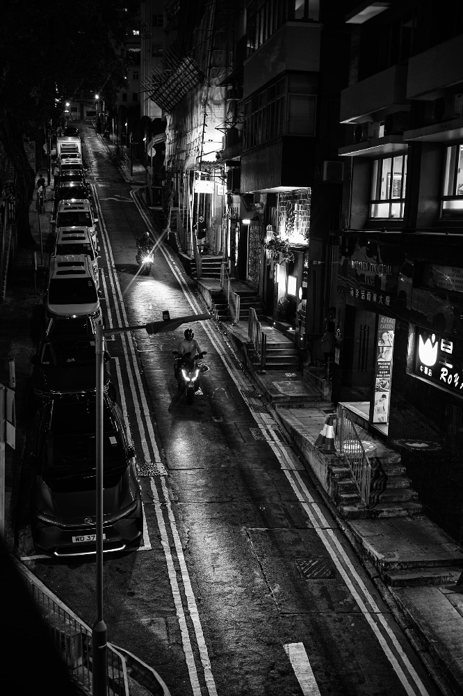 Black and white night street photograph in Hong Kong taken with a Leica Summicron 35mm 8-element