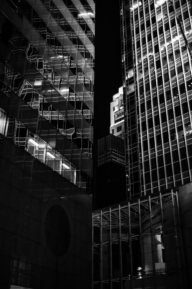 Black and white night photograph of an illuminated green wall, Leica Summicron 35mm 8-element
