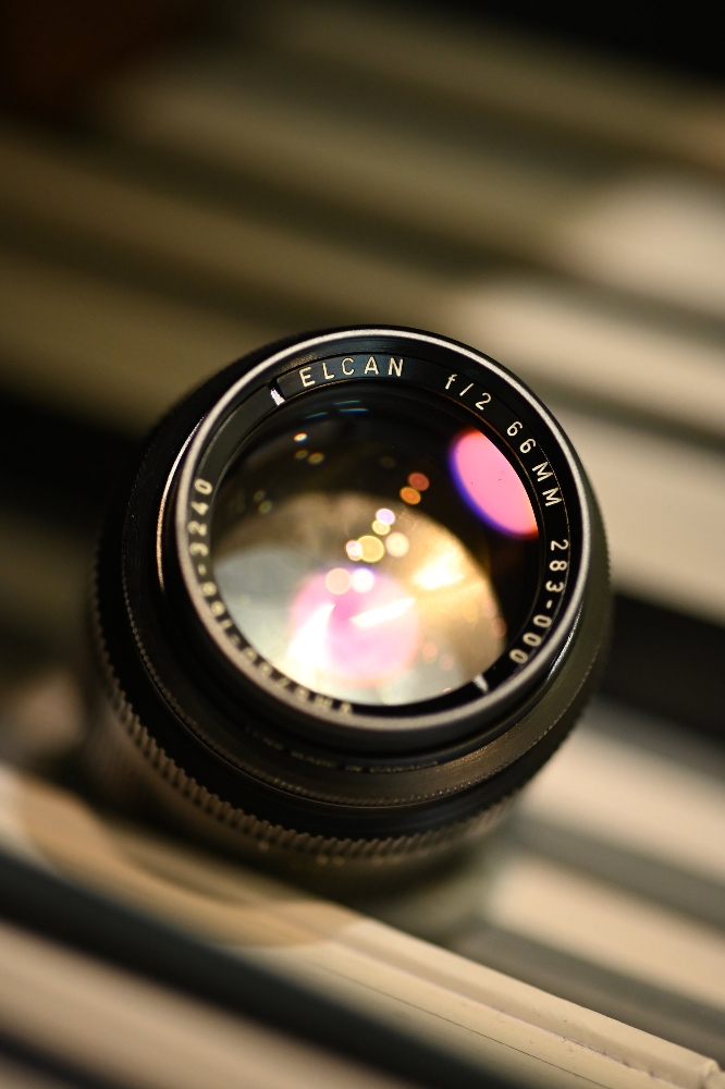Front element of an original ELCAN 66mm f/2 lens showing the ELCAN f/2 66MM 283-000 engraving and MADE IN CANADA marking